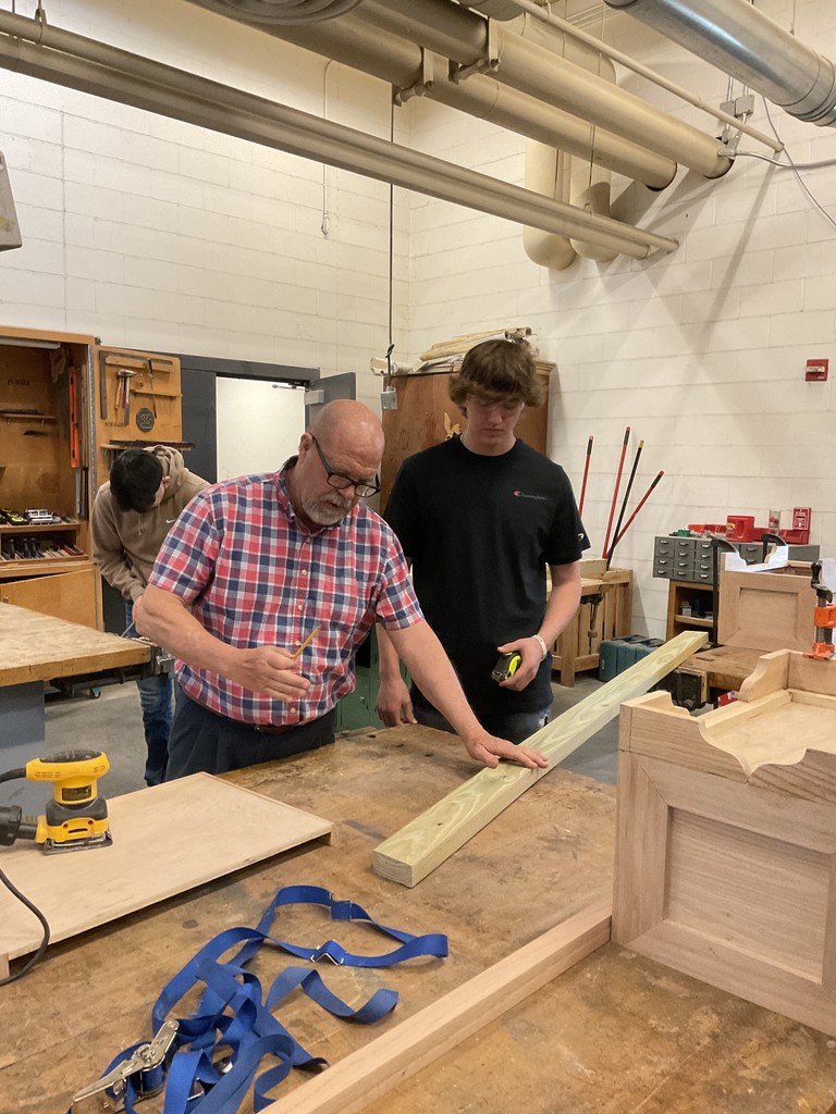 Mr. Andersen and Parker building the Buddy Bench