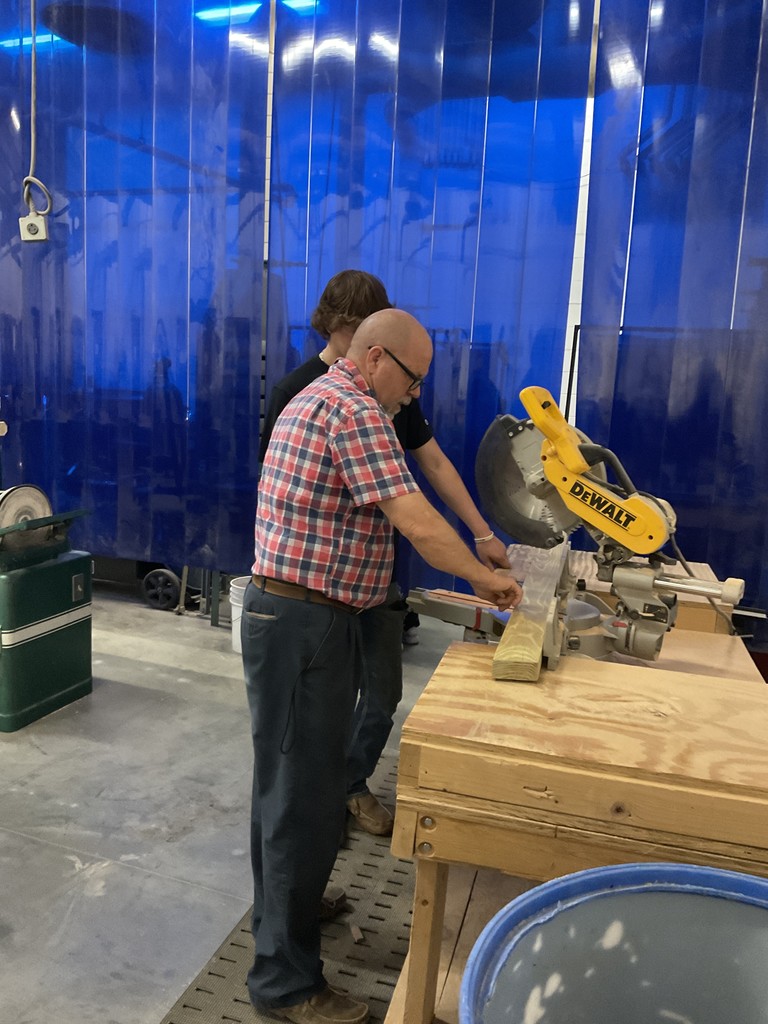 Mr. Andersen and Parker building a Buddy Bench